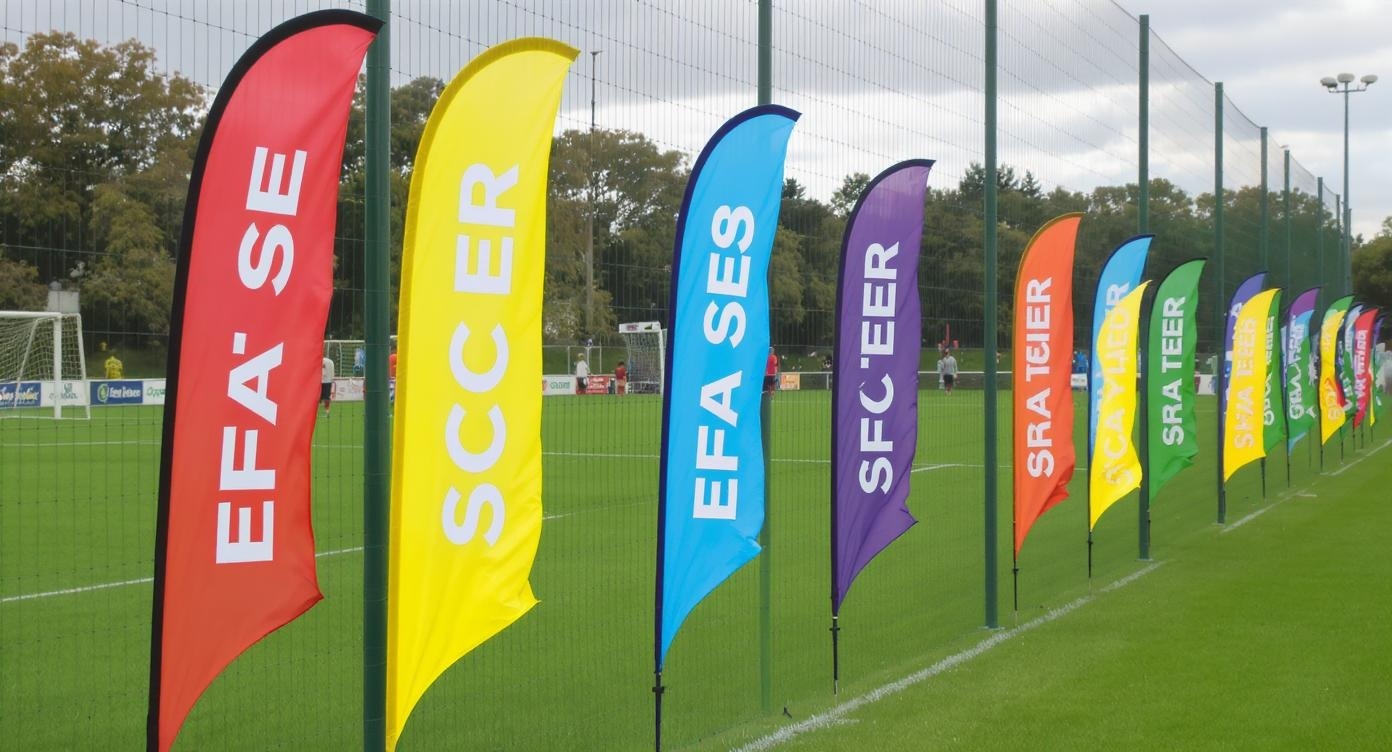 Soccer field sideline feather flags showing team pride and tournament energy Soccer field sideline feather flags showing team pride and tournament energy